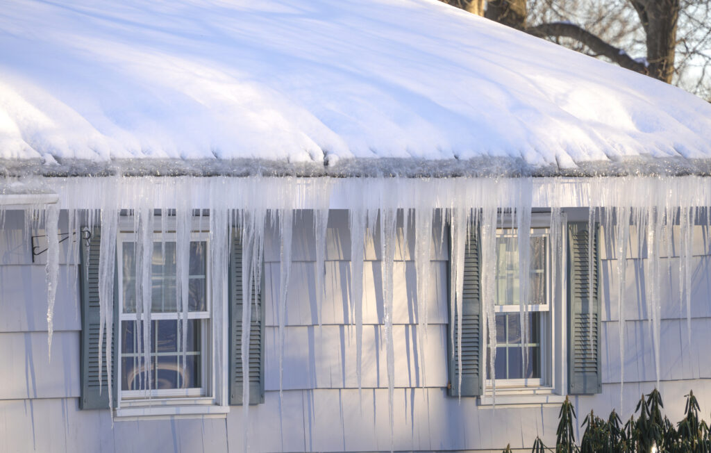 Ice Dams and Icicles Forming on Residential Roof