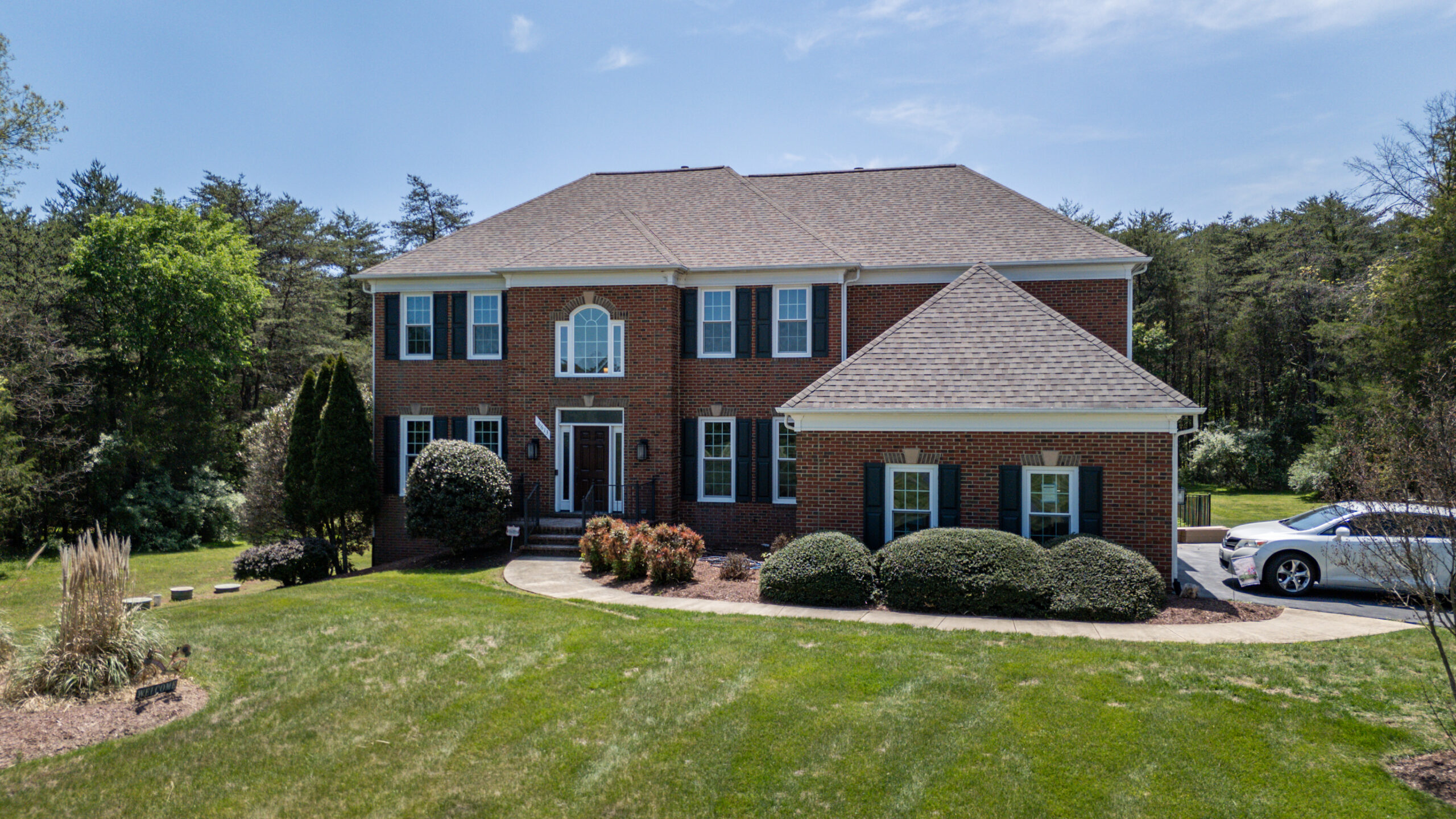 Traditional Fairfax County home after roof repair with new asphalt shingles