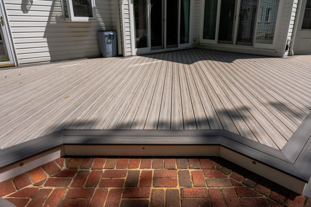 Low-profile ground-level deck creating a simple outdoor living area in a Reston VA backyard