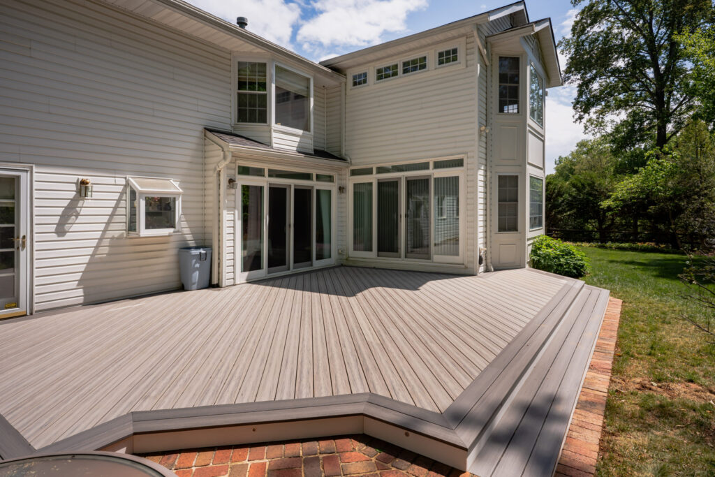 Ground-level deck with landscaped backyard
