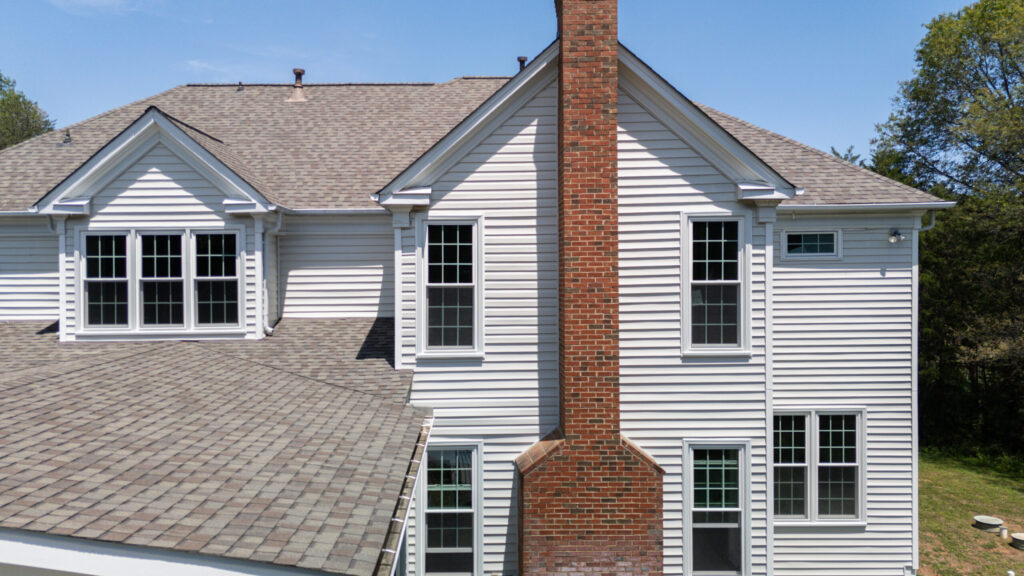 New downspouts directing rainwater away from a home's foundation